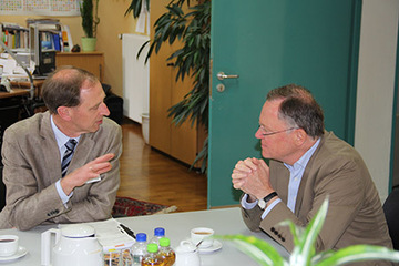 gespräch im Arbeitszimmer des Behördenleiters an einem kleinen Besprechungstisch