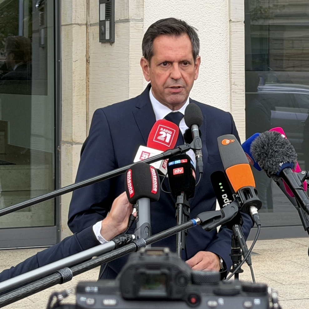 Ministerpräsident Olaf Lies steht vor der Niedersächsischen Staatskanzlei und spricht in vor ihm aufgebaute Mikrofone.